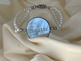 Bracelet with mirror on a beige colored background